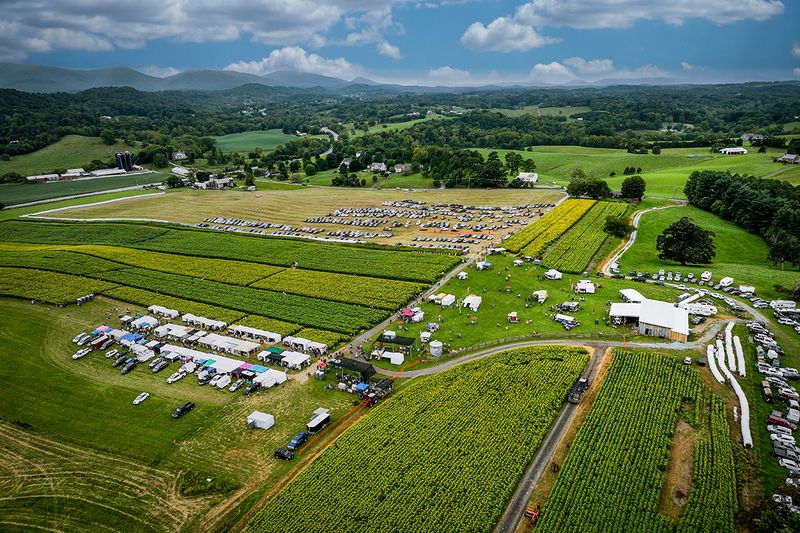Drone view of the festival: sunflower fields, vendor tents and parking set in the green Botetourt County valley.